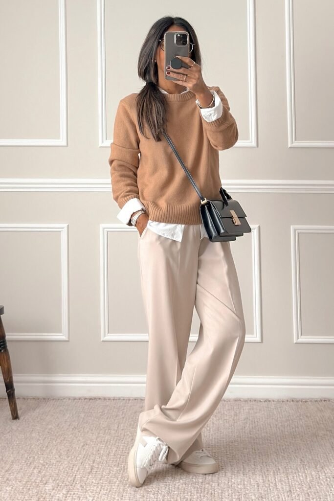 Camel Sweater + White Shirt + Beige Wide-Leg Trousers + White Sneakers + Black Crossbody Bag