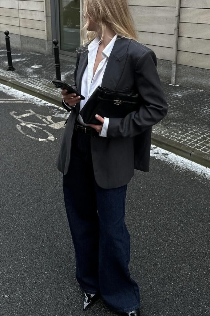 Charcoal Grey Blazer + White Button-Up Shirt + Dark Wash Wide Leg Jeans + Black Pointed Toe Boots + Black Clutch