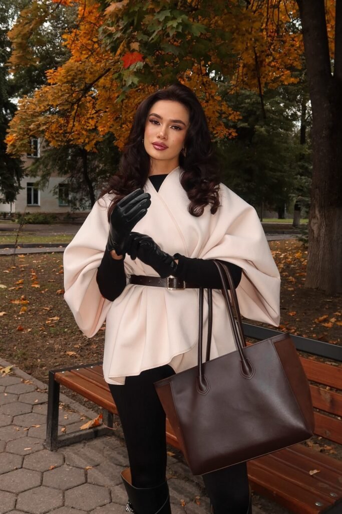Cream Belted Cape Coat + Black Turtleneck + Black Leggings/Trousers + Black Leather Gloves + Brown Leather Tote Bag