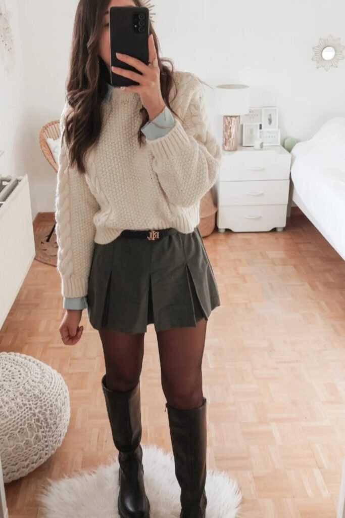 Cream Cable Knit Sweater + Light Blue Collared Shirt (Layered) + Olive Green Pleated Mini Skirt + Black Tights + Black Knee-High Boots