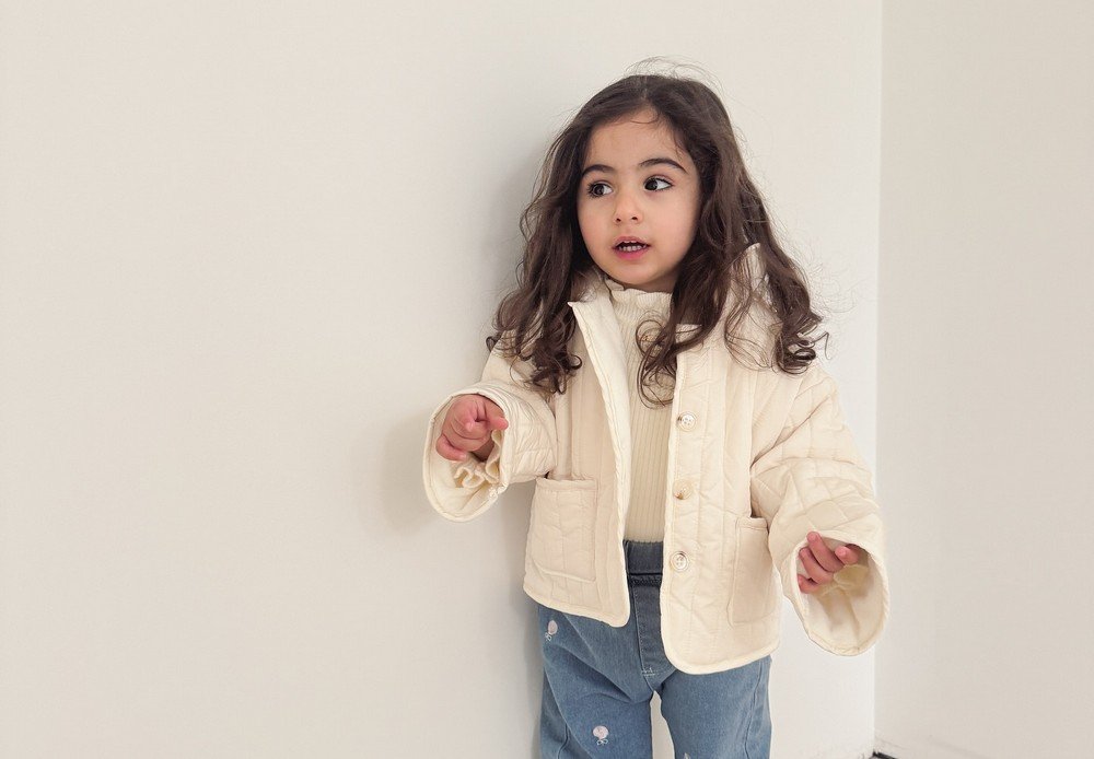 Cream Quilted Jacket + Cream Top + Blue Patterned Pants + White Sneakers