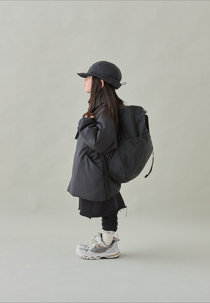 Dark Puffer Jacket + Black Skirt + Black Leggings + White Sneakers + Black Backpack