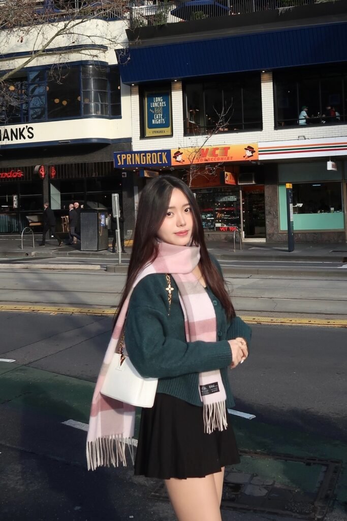 Forest Green Cardigan + Black Pleated Mini Skirt + Pink Plaid Scarf + White Shoulder Bag