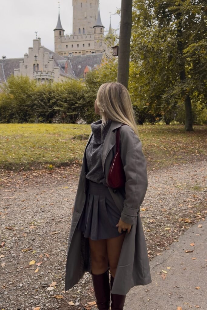 Grey Trench Coat + Grey Turtleneck Sweater + Grey Pleated Mini Skirt + Burgundy Knee-High Boots
