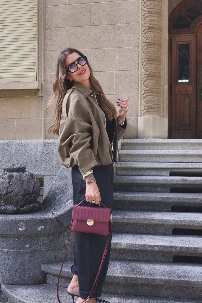 Khaki Green Bomber Jacket + Black Top + Black Wide-Leg Pants + Burgundy Crossbody Bag