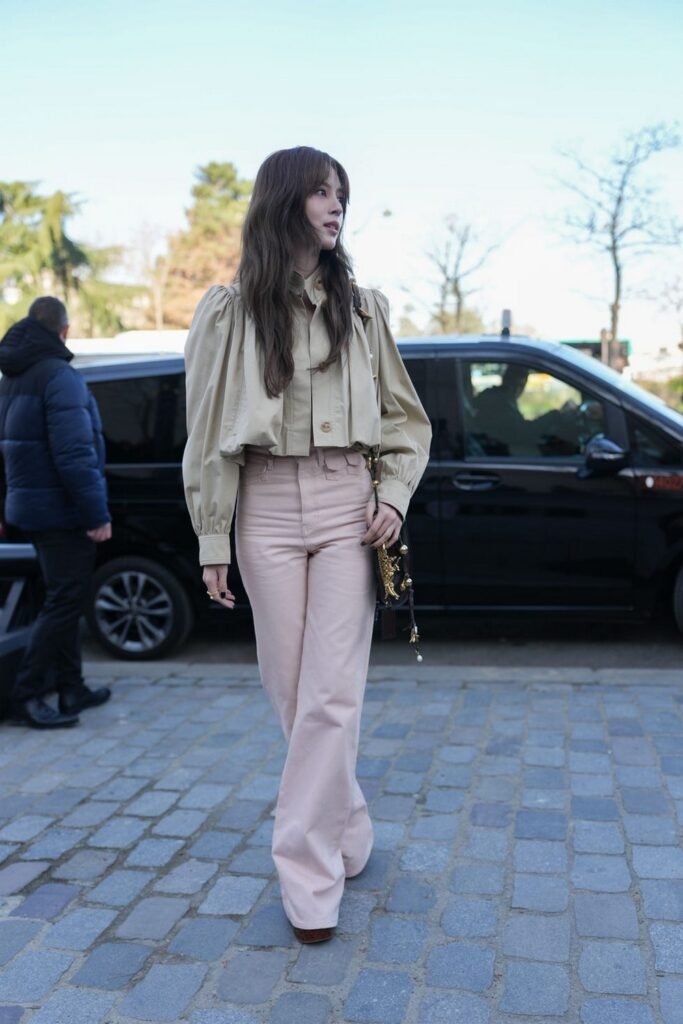 Light Beige Cropped Jacket + Light Pink Flared Trousers + Dark Brown Shoes + Dark Patterned Shoulder Bag