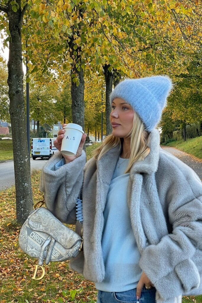 Light Blue Faux Fur Jacket + Light Blue Fluffy Beanie + Light Blue Sweater + Light Wash Jeans + Christian Dior Saddle Bag