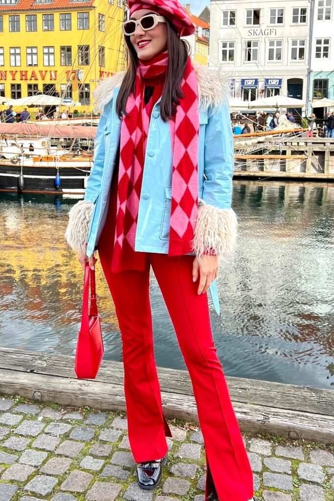 Light Blue Patent Jacket with Faux Fur Trim + Red Flared Trousers with Slits + Pink and Red Diamond Scarf + Red Beret + Red Shoulder Bag