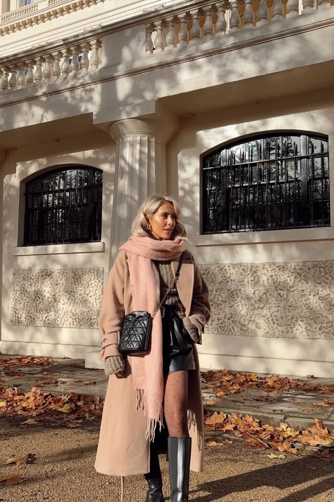 Long Camel/Beige Coat + Knitted Sweater + Black Leather Shorts + Sheer Black Polka Dot Tights + Pink Scarf + Black Knee-High Boots