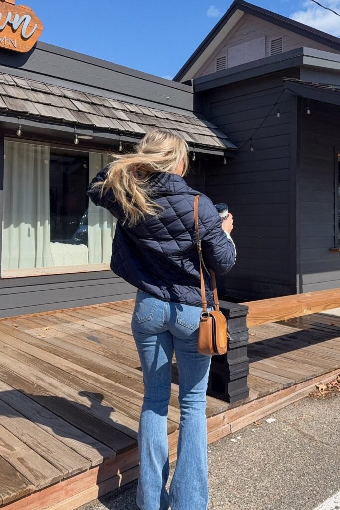 Navy Blue Quilted Puffer Jacket + Light Blue Flared Jeans + Tan Crossbody Bag