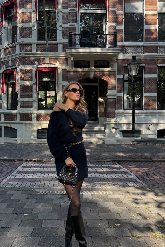 Navy Off-the-Shoulder Knit Mini Dress + Black Tights + Gold Chain Belt + Black Knee-High Boots