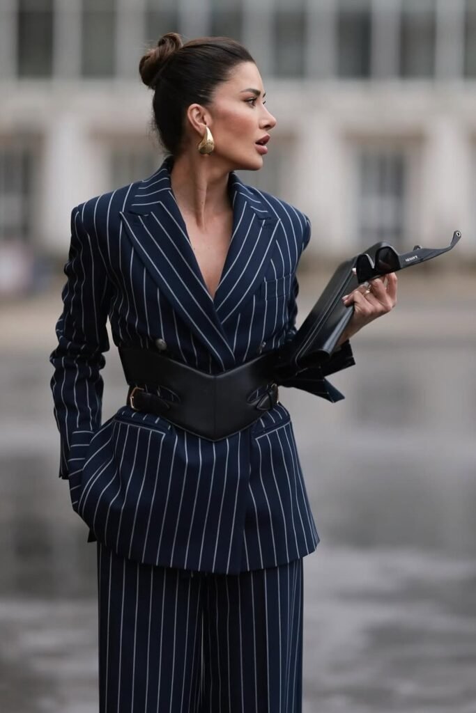 Navy Pinstripe Suit + Black Structured Belt + Gold Hoop Earrings + Black Handbag