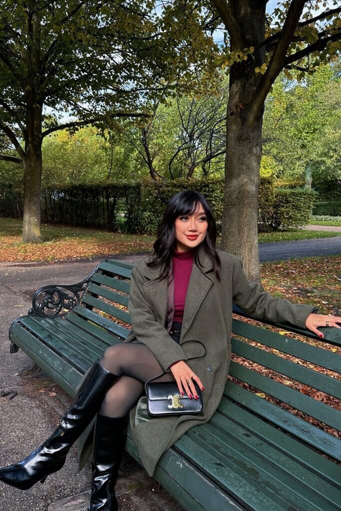 Olive Green Wool Coat + Burgundy Turtleneck + Black Mini Skirt + Sheer Black Tights + Black Knee-High Boots + Black Shoulder Bag