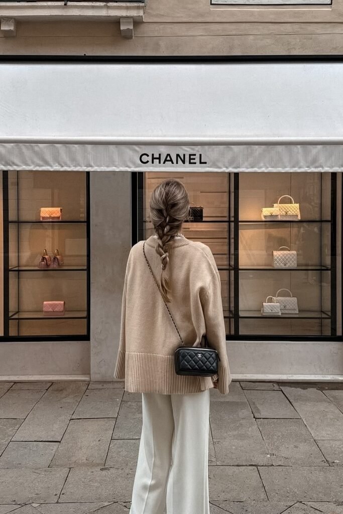 Oversized Beige Ribbed Turtleneck Sweater + Cream Wide-Leg Trousers + Black Quilted Crossbody Bag