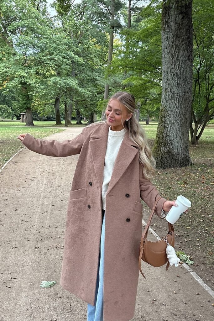 Oversized Long Mauve Coat + Cream Knit Sweater + Light Blue Jeans + Brown Shoulder Bag