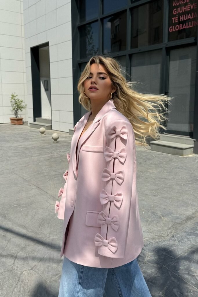 Pink Blazer with Bow Detailing on Sleeves + Light Wash Wide-Leg Jeans + Gold Hoop Earrings