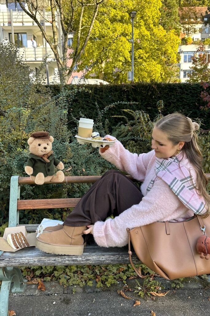 Pink Fluffy Sweater + Brown Wide-Leg Trousers + Tan Platform Boots/Slippers + Pink Plaid Scarf + Tan Tote Bag