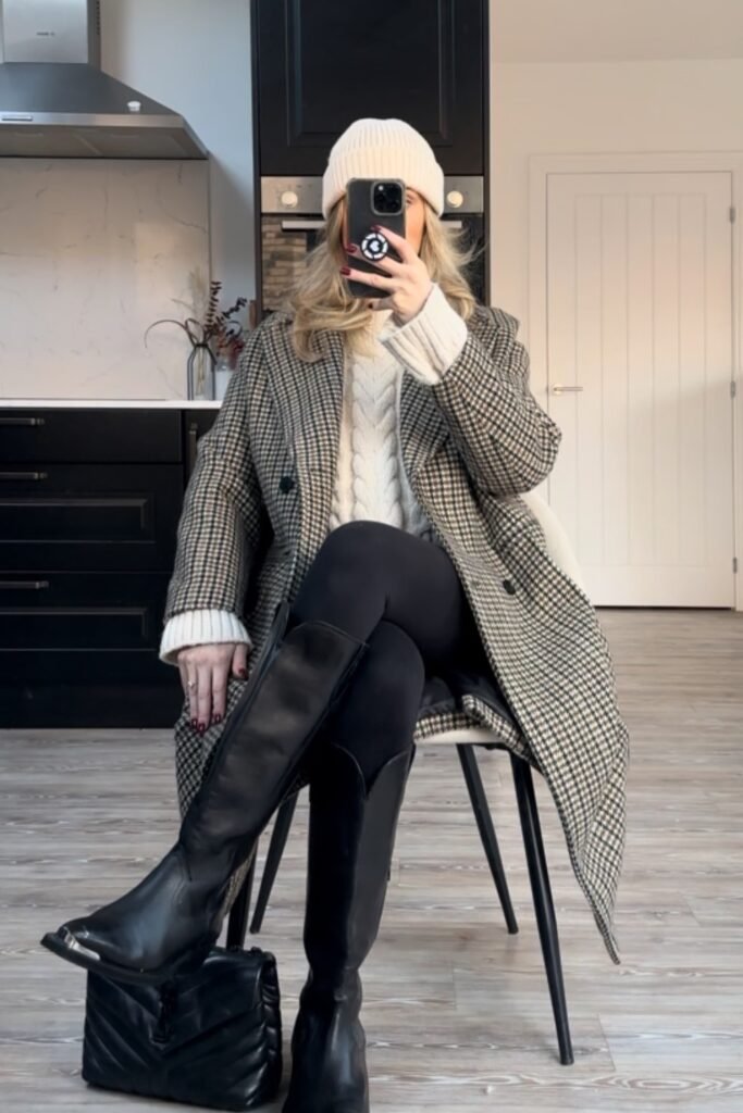 Plaid Coat + Cream Cable-Knit Sweater + Black Leggings + Black Knee-High Boots + Cream Beanie