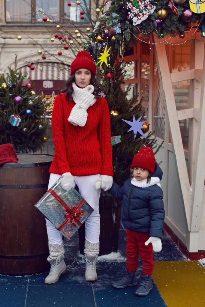 Red Cable-Knit Sweater + White Skinny Jeans + Grey Winter Boots + Matching Red Beanie