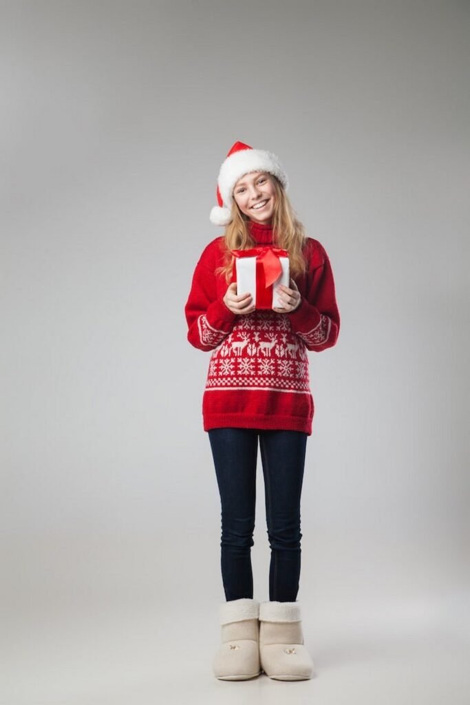 Red Fair Isle Sweater + Dark Blue Skinny Jeans + Cream Fur-Lined Booties + Santa Hat