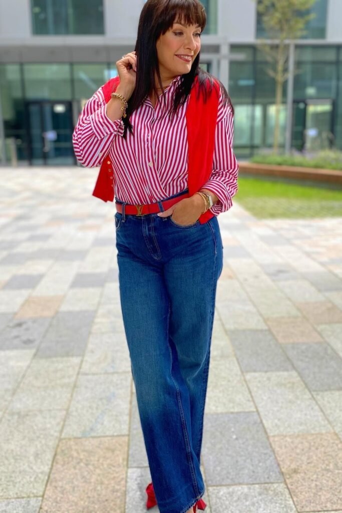 Red and White Striped Blouse + Red Vest/Sweater + Dark Wash Straight-leg Jeans + Red Heels