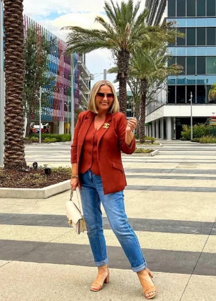 Rust Blazer + Rust Button-Front Vest + Medium Wash Cuffed Jeans + Tan Block Heels + Cream Handbag