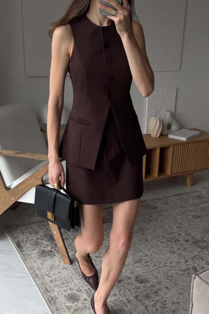 Sleeveless Dark Brown Buttoned Mini Dress + Brown Flats + Black Structured Handbag + Gold Ring