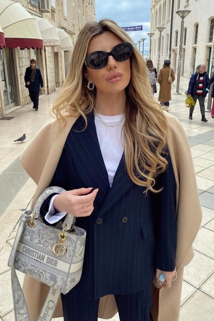 Tan Cape/Coat + Black Pinstripe Double-Breasted Suit Jacket + White T-Shirt + Grey Logo Tote Bag