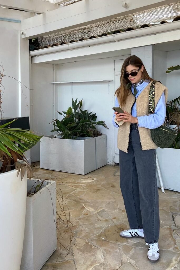 Tan Teddy Vest + Light Blue Shirt + Dark Gray Wide-Leg Jeans + White Sneakers