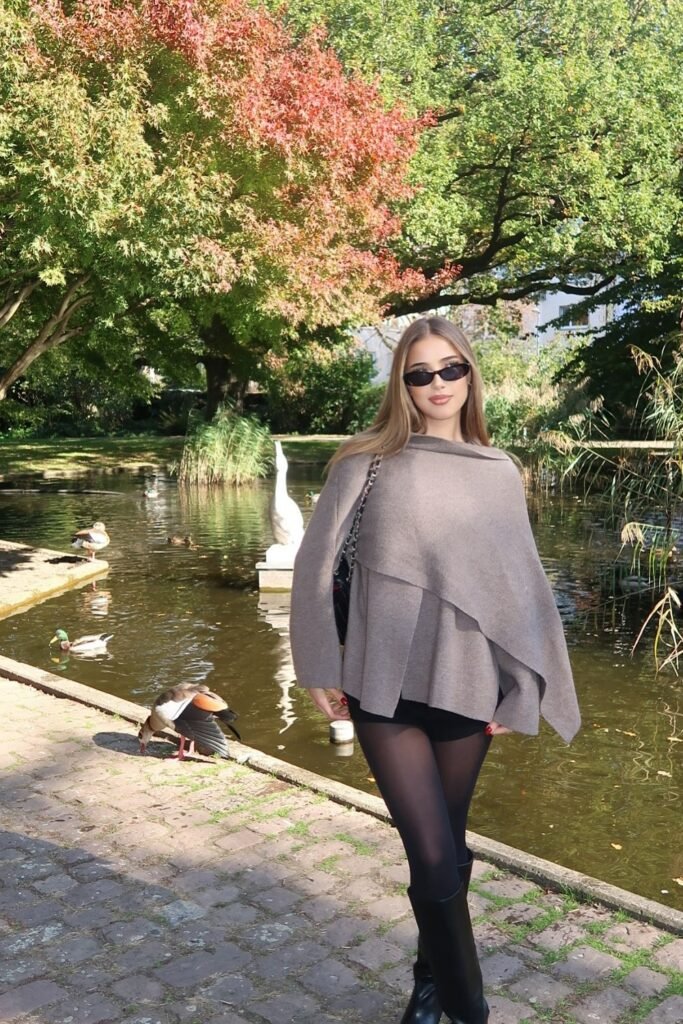 Taupe Off-Shoulder Poncho + Black Shorts + Black Tights + Black Knee-High Boots