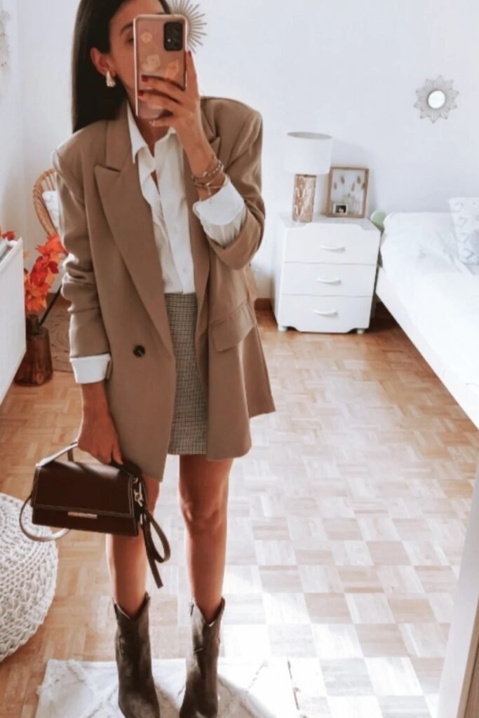 Taupe Oversized Blazer + White Button-Up Shirt + Plaid Mini Skirt + Dark Brown Cowboy Boots + Dark Brown Top-Handle Bag