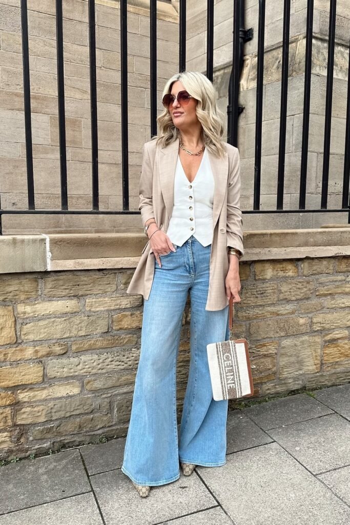 White Button-Up Vest + Tan Blazer + Light Blue Wide-Leg Flared Jeans + Snake Print Pointed Heels + White and Tan Structured Handbag