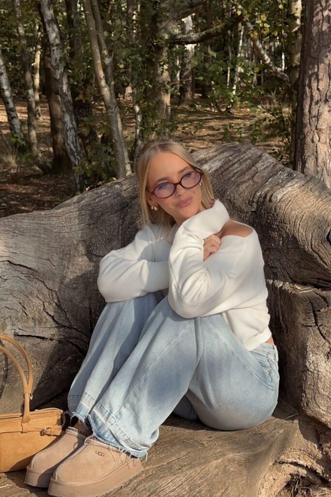 White Cut-Out Turtleneck Sweater + Light Wash Wide-Leg Jeans + Tan Suede Mules + Oval Glasses