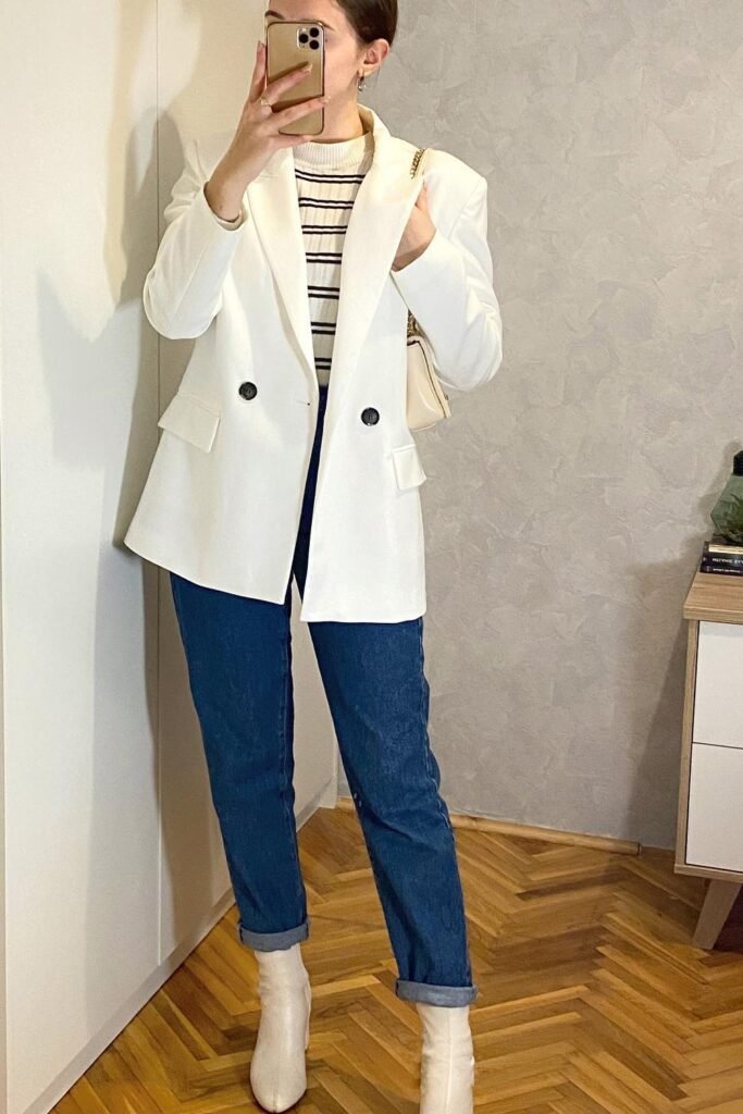 White Double-Breasted Blazer + Black and White Striped Sweater + Cuffed Dark Wash Jeans + White Ankle Boots + White Shoulder Bag