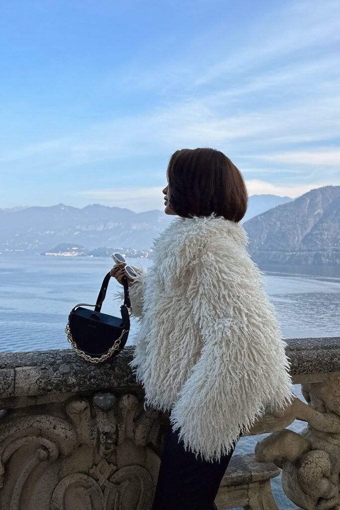 White Fluffy Faux Fur Jacket + Black Pants + Black Chain Bag + White Sunglasses