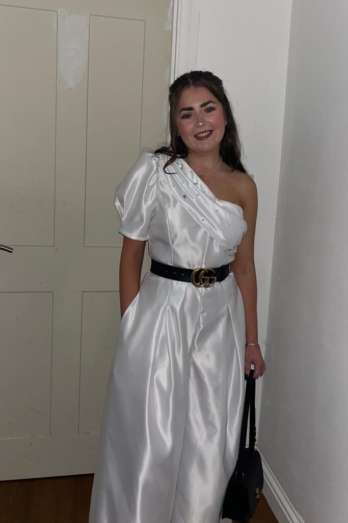 White One-Shoulder Jumpsuit + Black Gucci Belt + Black Handbag