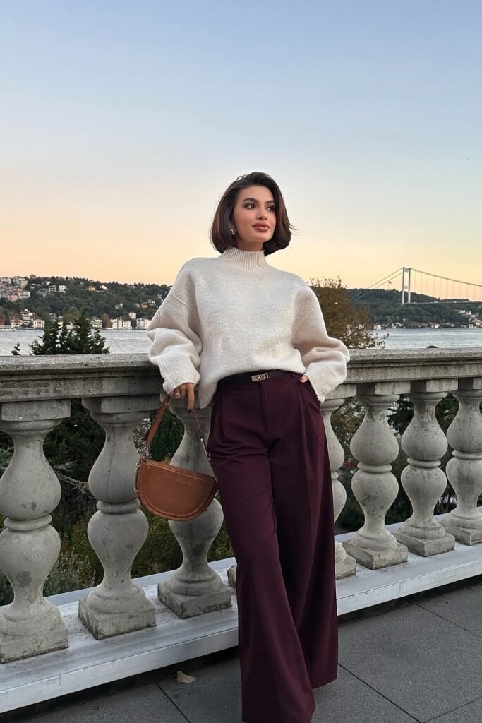 White Oversized Knit Sweater + Burgundy Wide-Leg Trousers + Brown Half-Moon Bag
