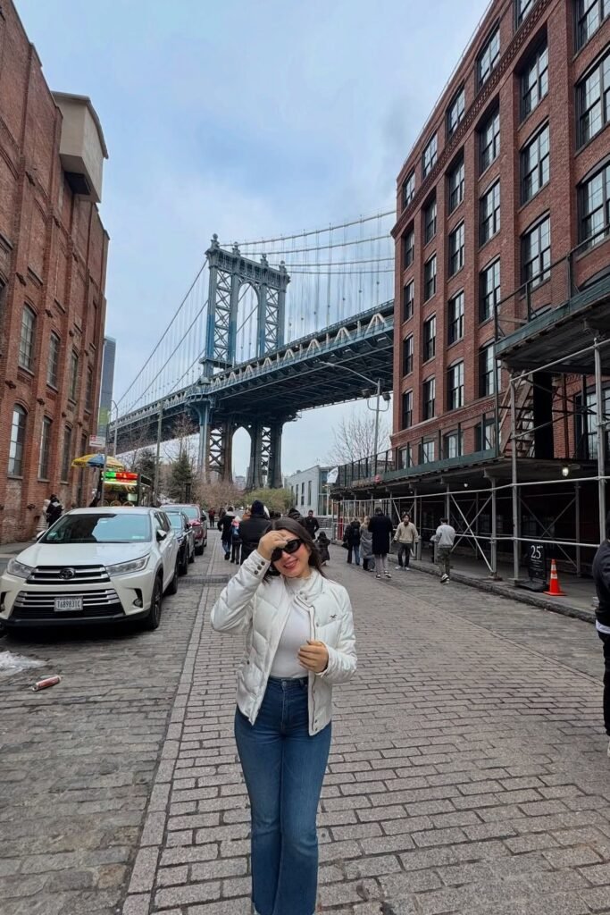 White Puffer Jacket + White Turtleneck Top + Flared Blue Jeans + Sunglasses