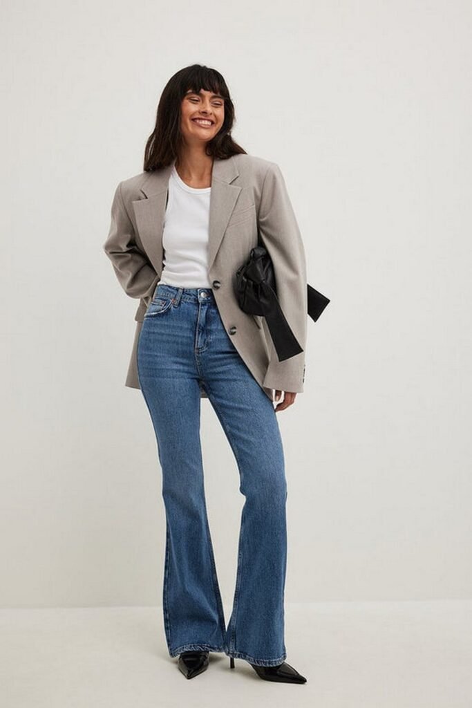White T-shirt + Grey Oversized Blazer + Blue Flared Jeans + Black Pointed Heels + Black Clutch
