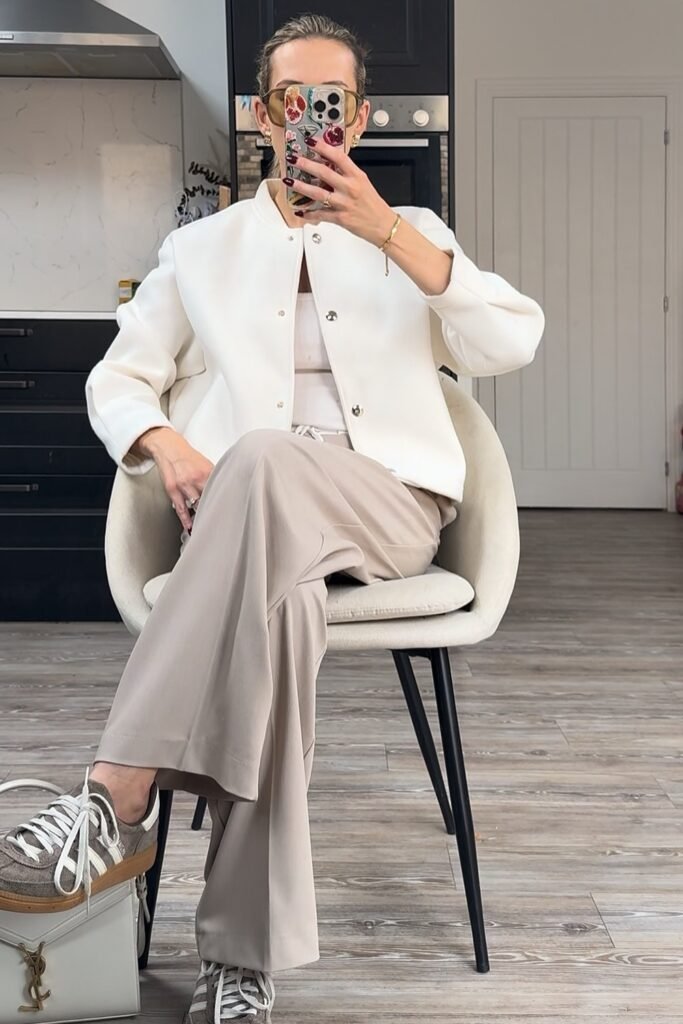 White Tank Top + Beige Wide-Leg Trousers + White Cropped Bomber Jacket + Grey Sneakers