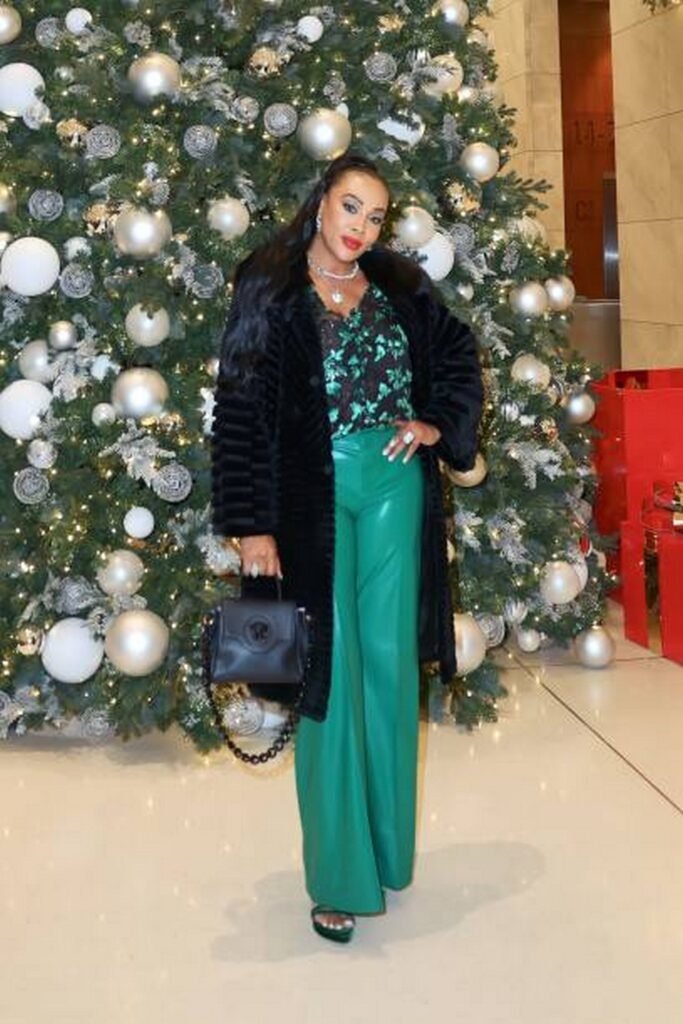 Black Faux Fur Coat, Floral Top, and Green Faux Leather Trousers