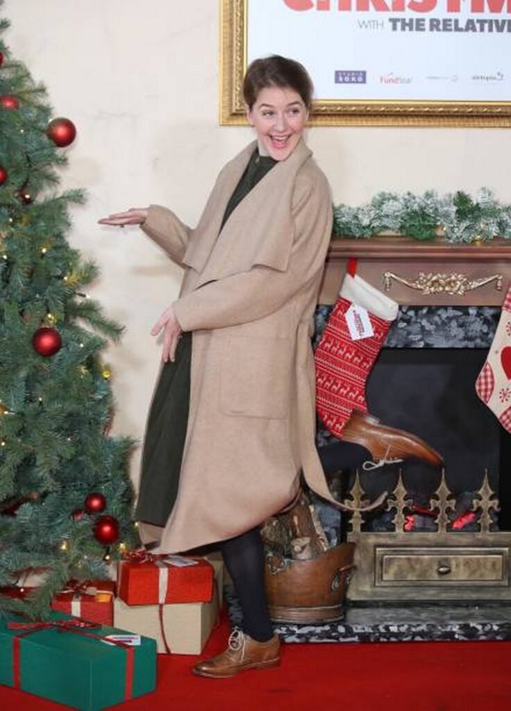 Camel Wrap Coat over Dark Green Dress, Black Tights, and Brogues