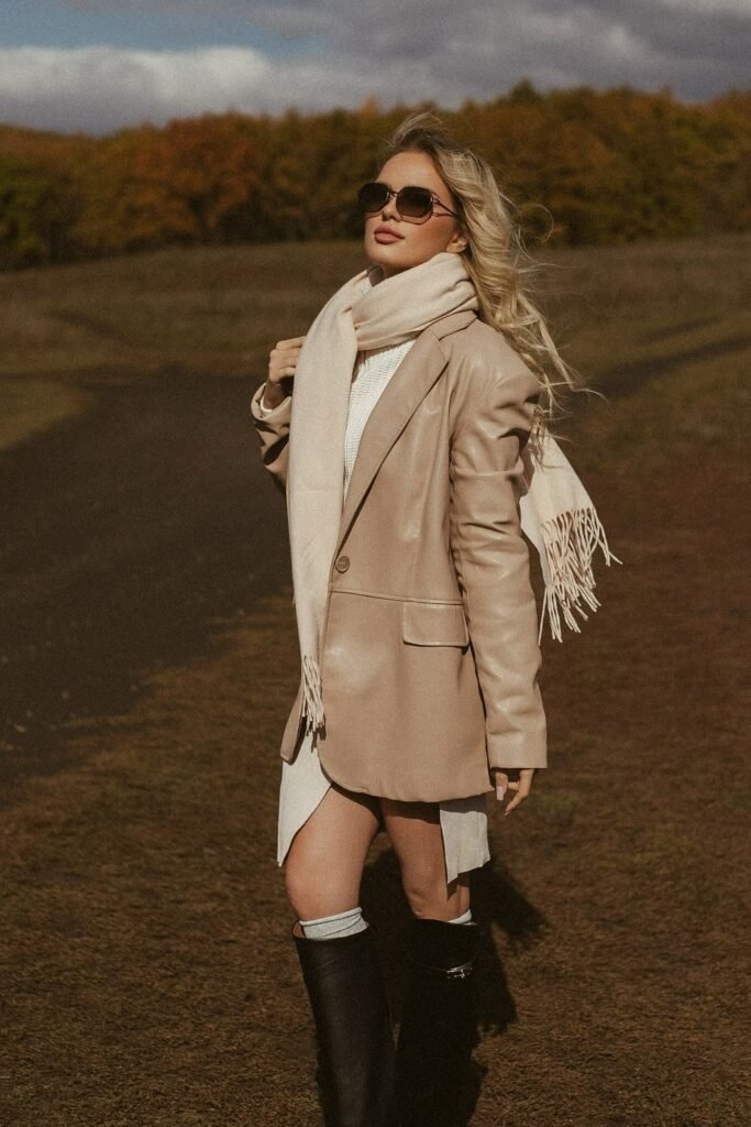 Beige Faux Leather Blazer + Cream Knit Scarf + White Dress + Black Riding Boots