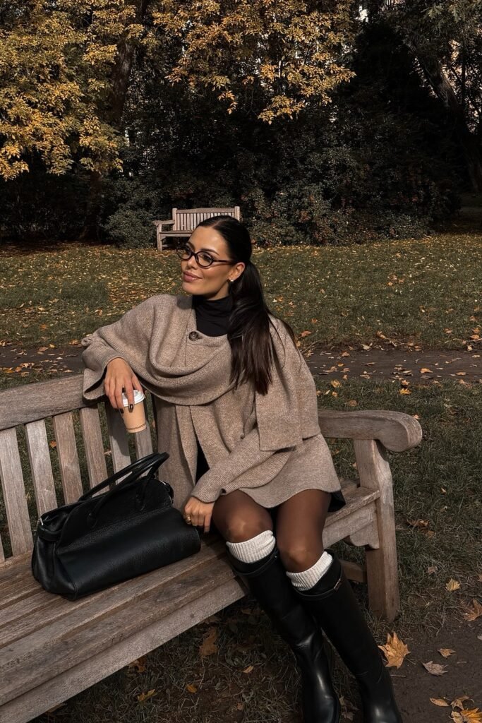 Beige Knit Poncho/Cape + Black Turtleneck + Tights/Shorts + Black Knee-High Boots + White Socks