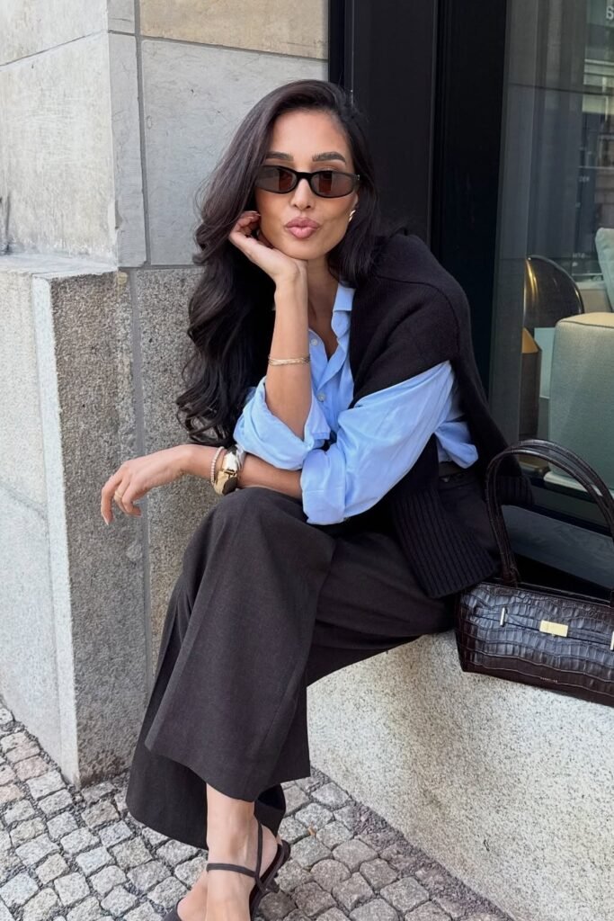 Black Sweater Vest + Light Blue Collared Shirt + Dark Brown Wide-Leg Trousers + Black Sandals