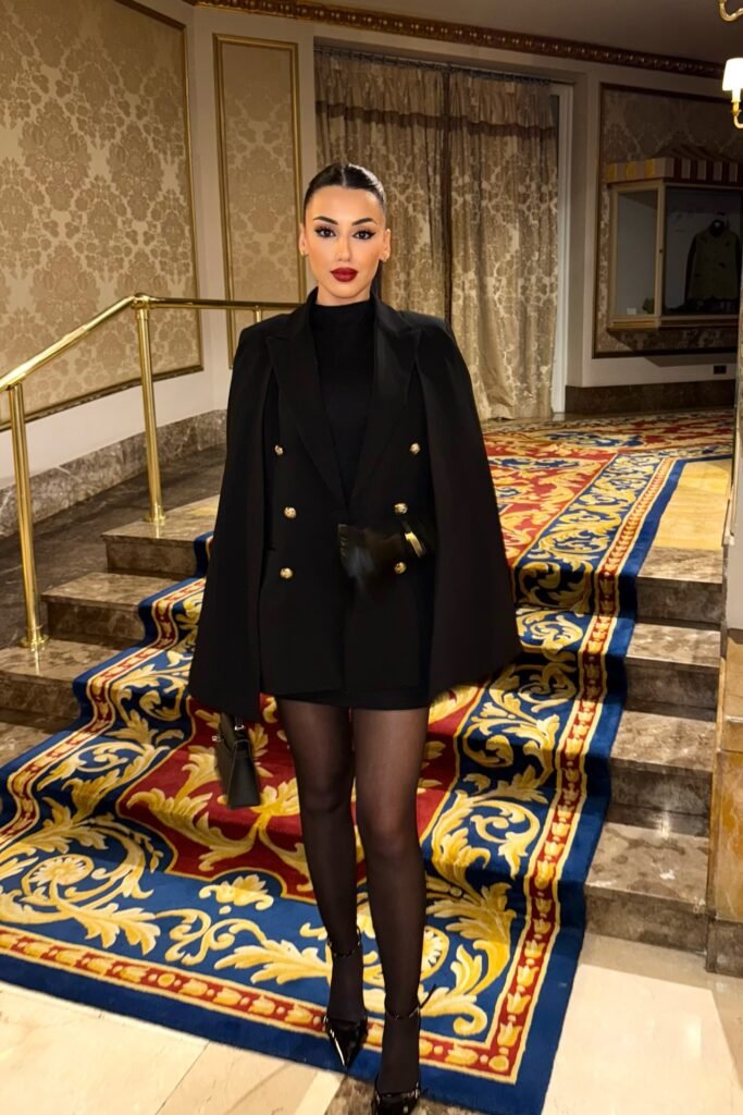 Black Turtleneck Mini Dress + Black Double Breasted Cape Blazer + Sheer Black Tights + Black Pointed Heels