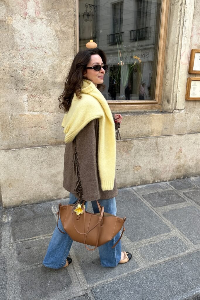 Brown Fringed Wool Jacket + Butter Yellow Sweater (draped) + Mid-Wash Flared Jeans + Two-Tone Ballet Flats