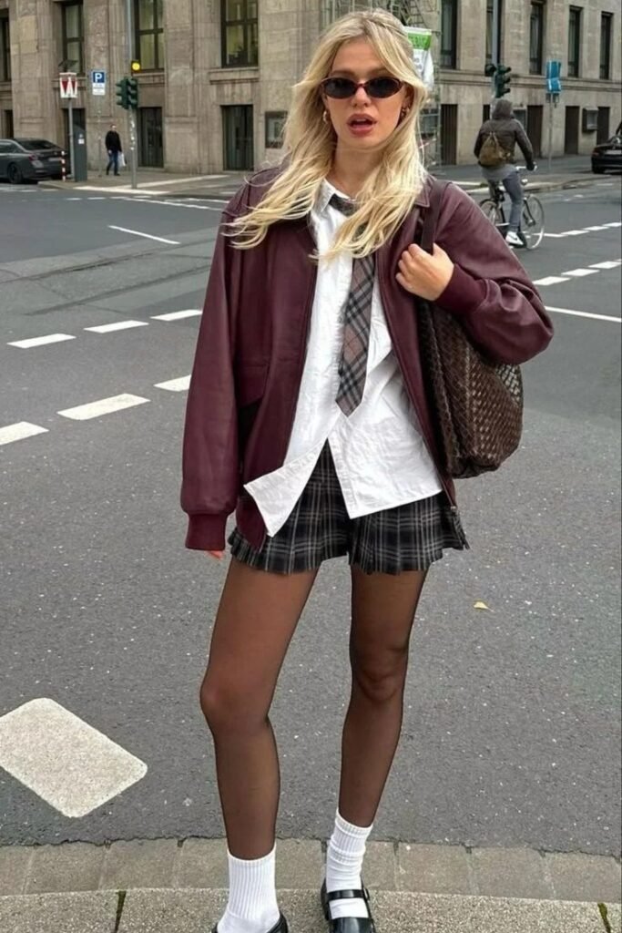 Burgundy Leather Bomber Jacket + White Button-Down with Plaid Tie + Plaid Mini Skirt + Black Mary Janes with White Socks