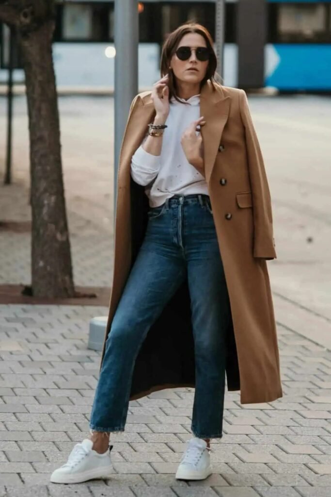 Camel Longline Overcoat + Medium Wash Straight-Leg Jeans + White Sneakers