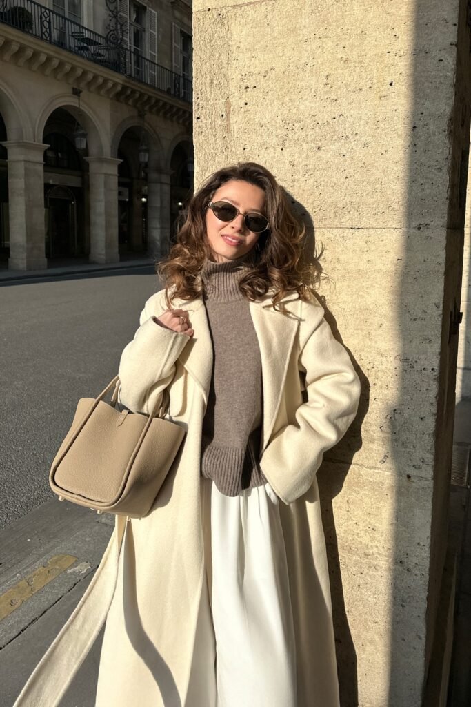 Cream Oversized Wool Coat + Taupe Turtleneck Sweater + White Silk Trousers + Beige Tote Bag